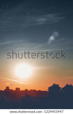 Starry sky over the city. Silhouette of houses on the horizon. Toned photo. Background use in cover design