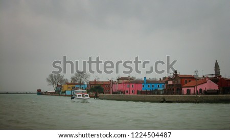  Colorful houses in Burano island seen from the sea.