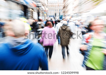 picture with camera made zoom effect of crowds of people in a shopping street
