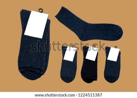Natural wool socks. Warm socks. Socks with label. Socks on a brown background.