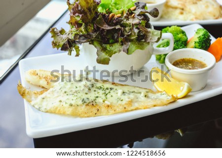 Grilled Pangasius with white cream sauce, serve with fresh salad.