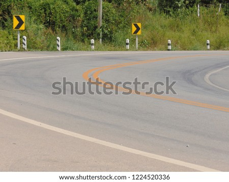 Roads with dangerous curves have traffic signals to warn for safety.