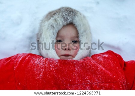 A resident of the tundra, indigenous residents of the Far North, tundra, open area, Girl lying on the snow, children  in national clothes