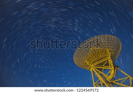 In observatories,satellite antenna radio telescope on the background of stellar tracks