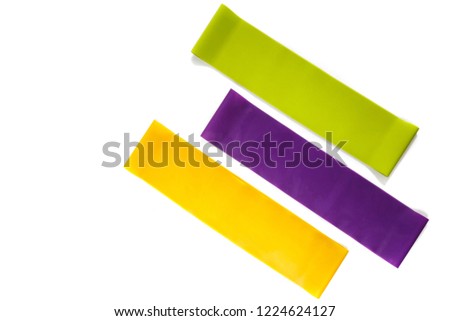 Fitness elastic band, elastic extenders of different colors for sports, isolated on a white background. Fitness trend Royalty-Free Stock Photo #1224624127