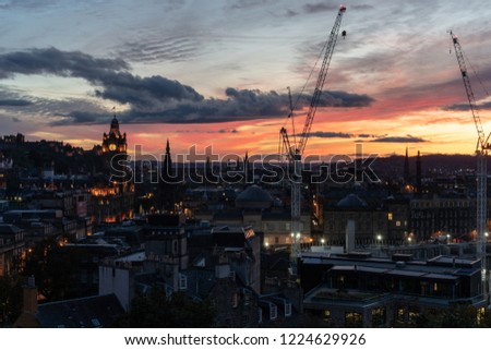 View of Edinburgh in sunset light from the side with hanging tower.