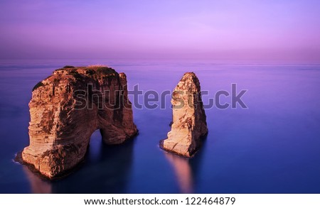 Picture of Rawsha rock on beautiful purple sunset, coastline of Mediterranean sea, calm peaceful weather, famous Lebanese landmark in the water in evening, gorgeous landscape, tourism conception