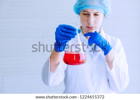 The scientist test new product by test tube.
