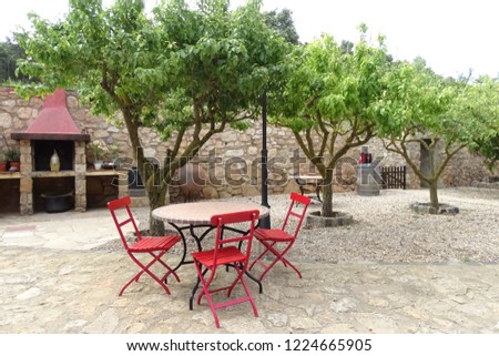 red chairs and table in the garden, relaxing idyllic place