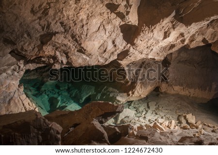 In the cave. The place where the water of underground river go under the stone arch. Karst cave Leningradskaya in Abkhazia.