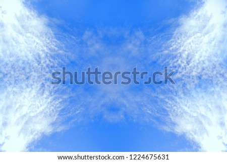 Symmetric reflexion white fluffy clouds in the pure blue sky
