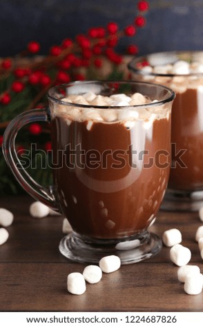 A Pair of Mugs Filled with Hot Chocolate and Marshmallows on a Wooden Table