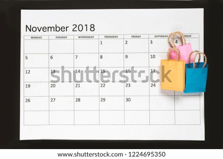 A cart from the store on the calendar November. Shopping, discounts and sales on black Friday November