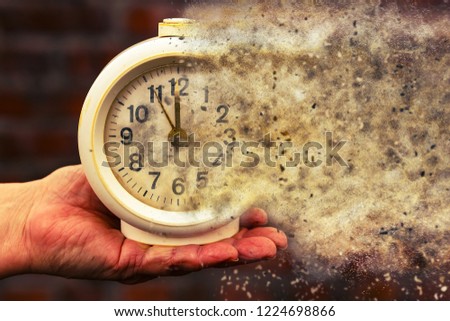 Five minutes to twelve. Time is running out concept shows clock that is dissolving away into little particles