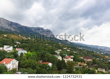 View of the resort village of Alupka and AI-Petri mountain on a cloudy day. Crimea, Russia