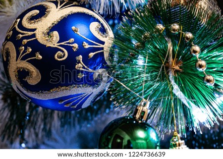Festive Christmas composition, decorations on the Christmas tree, gift boxes, packaging and tinsel and silver beads. Toys and decorations for new year's eve. Various cones, balls, coasters and lantern