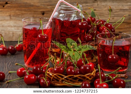 Cherry juice and fresh cherry on a wooden background. Fresh cherry juice in a glass. Fresh cherry on the wooden table.
Fresh ripe red.