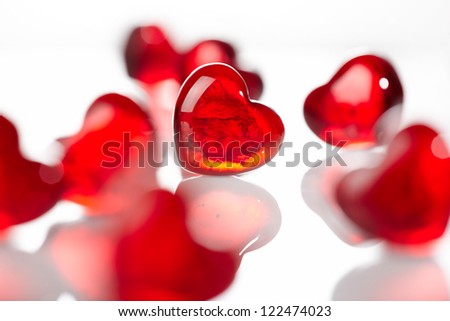 Red glass hearts on white background