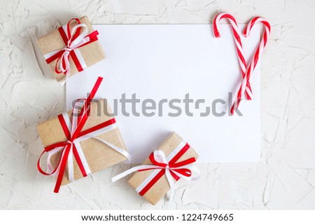 Christmas gifts and candy cane with with blank greeting card.