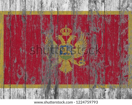 Montenegro  flag painted on old wood plank background