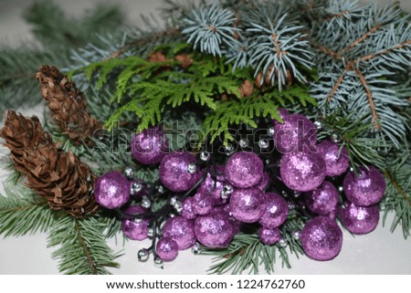 Christmas decoration: pink and lilac balls with cones and fir tree branches