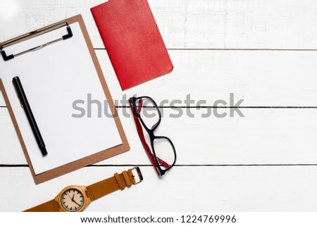 Top view of work objects on the rustic wooden background with copy space for insertion of your mensage or design elements.