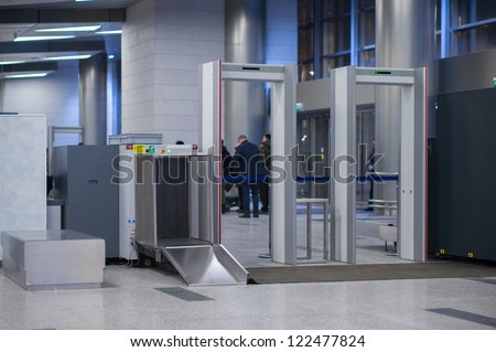 Security gates with metal detectors and scanners at entrance of airport Royalty-Free Stock Photo #122477824