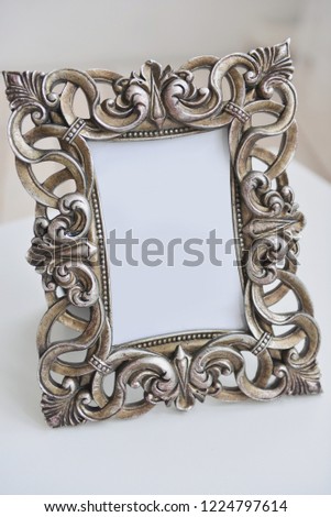 photo frame stands on the table, close-up. Vintage style, modern, baroque