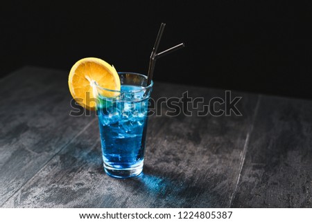 Fresh tasty drinks on black background with fruits