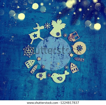 christmas and new year background with tree decorations,figures of houses,snowflakes,star on the blue rustic background/fir brunch with ball /concept