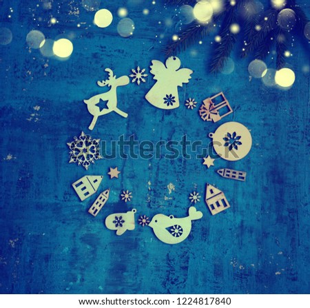 christmas and new year card with tree decorations,figures of houses,snowflakes,star on the blue rustic background/fir brunch with ball /concept