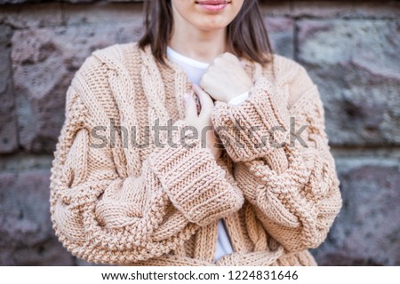 Girl standing in a handmade cardigan Royalty-Free Stock Photo #1224831646