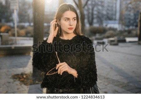 Girl stand on the park background and pose to camera