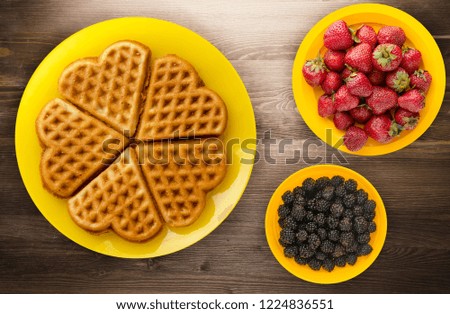 Belgian waffles wooden background. waffles on a plate top view