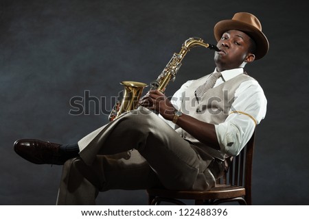 Black american jazz saxophone player. Vintage. Studio shot. Royalty-Free Stock Photo #122488396