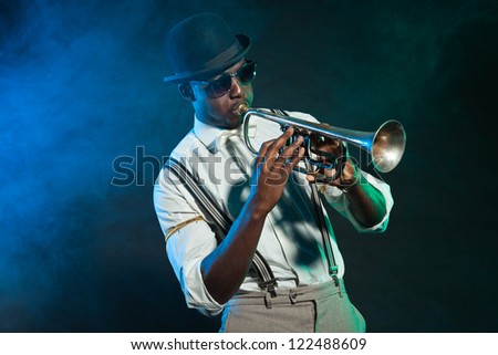 Black african american jazz trumpet player. Vintage. Studio shot. Royalty-Free Stock Photo #122488609