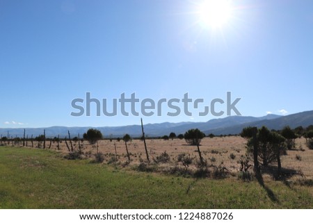 A glowing sun over a western landscape in Sanpete county Utah