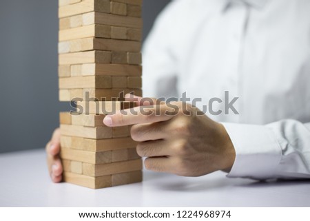 Wooden block Planning, risk and strategy of project management in business, with hand pull wood block.