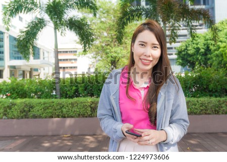 Business asian women standing in green park city lifestyle