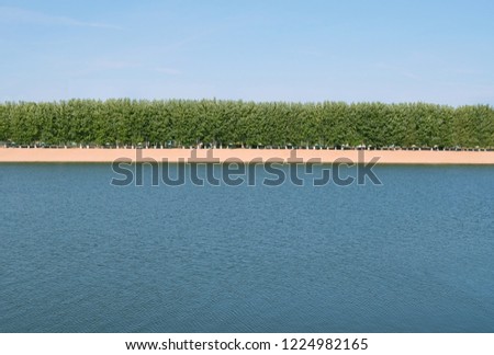 minimalistic summer landscape with river and beach.natural summer background with water and beach.  Minimalist summer scene. Russia, Tver, Volga river. 