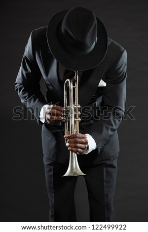 Black african american jazz trumpet player. Vintage. Studio shot. Royalty-Free Stock Photo #122499922