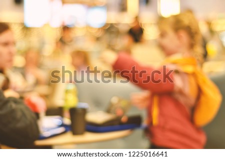 Blurred background. Blurred silhouettes of sitting people in coffee