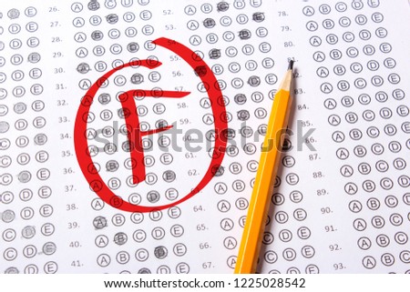 Bad grade F is written with red pen on the tests Royalty-Free Stock Photo #1225028542