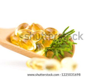 Healthy Vitamins, Omega 3,isolated, has a white background.Copy space,vitamin capsule concept For happiness, put on a wooden spoon to give yellow color.
