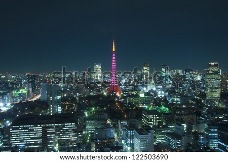 Illuminated Tokyo Tower standing out from Tokyo Metropolis skyline at dusk