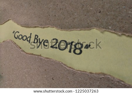 The text good bye 2018 word appearing behind torn paper.