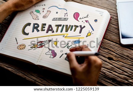 Man drawing creativity in a notebook