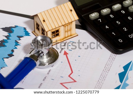House and stethoscope, economic stock market statistics, real estate economic development issues and remediation