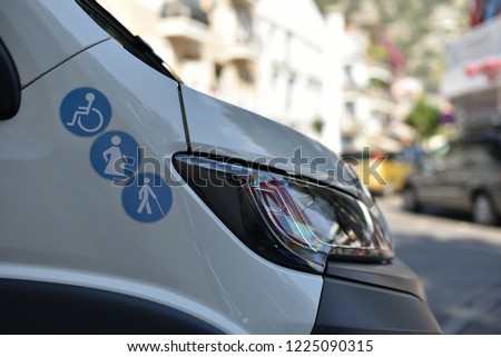 signs on a minibus for the comfortable transportation of disabled people, pregnant women and the elderly