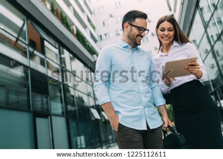 Picture of young attractive business partners standing